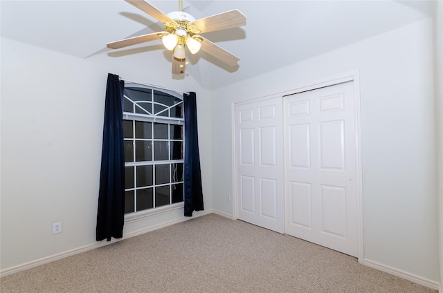 unfurnished bedroom featuring light carpet, a closet, and ceiling fan