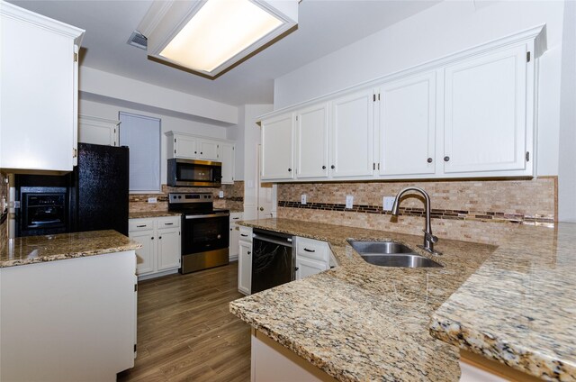 kitchen featuring black appliances, white cabinets, sink, decorative backsplash, and light stone counters