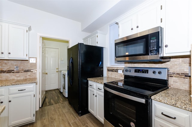 kitchen with white cabinets, decorative backsplash, and stainless steel appliances