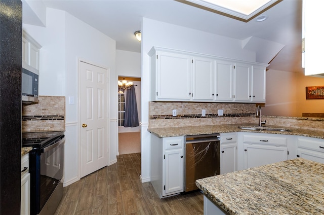 kitchen featuring white cabinets, black range with electric stovetop, sink, tasteful backsplash, and light stone counters