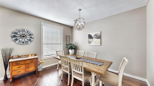 dining room featuring dark wood-type flooring, a chandelier, and a textured ceiling