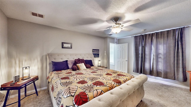 bedroom with a textured ceiling, ceiling fan, and light colored carpet