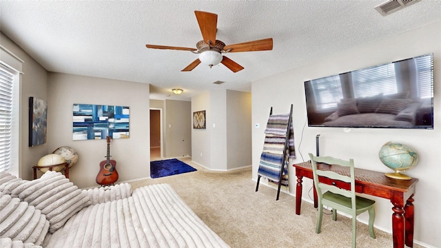 bedroom featuring light carpet, ceiling fan, and multiple windows