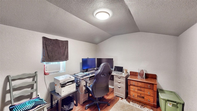 home office featuring hardwood / wood-style flooring, cooling unit, lofted ceiling, and a textured ceiling