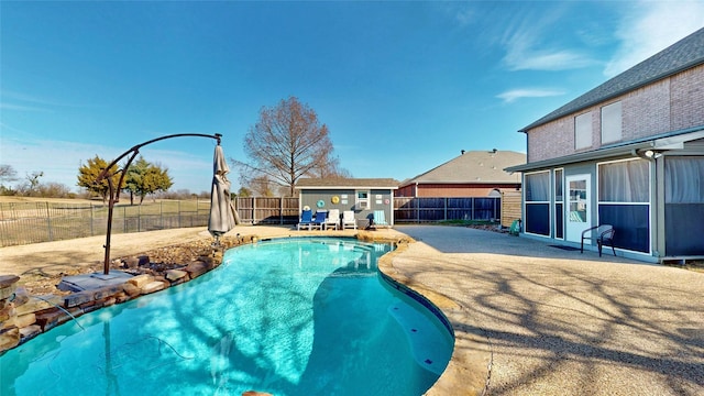 view of swimming pool with an outdoor structure and a patio