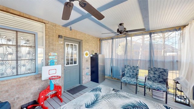 sunroom / solarium with ceiling fan and beam ceiling