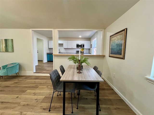 dining space with wood-type flooring