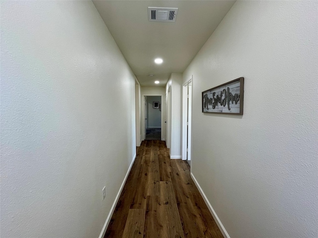 hallway with dark hardwood / wood-style floors