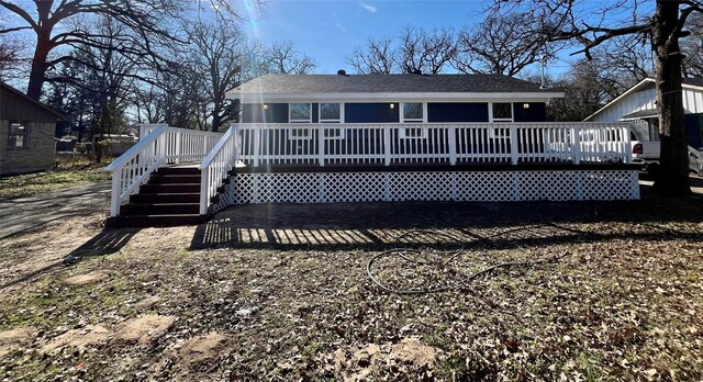 back of property with a wooden deck