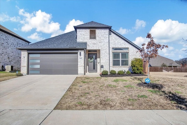 view of front of home featuring a garage and cooling unit