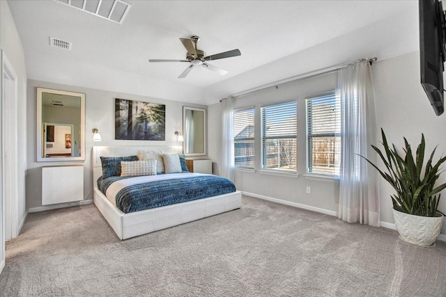 bedroom with ceiling fan and light carpet