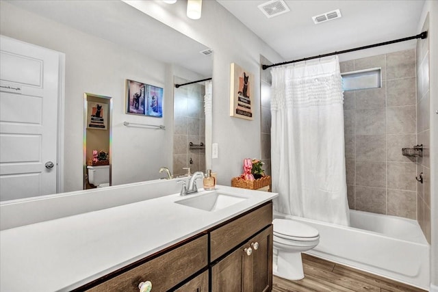 full bathroom featuring wood-type flooring, vanity, toilet, and shower / bath combination with curtain