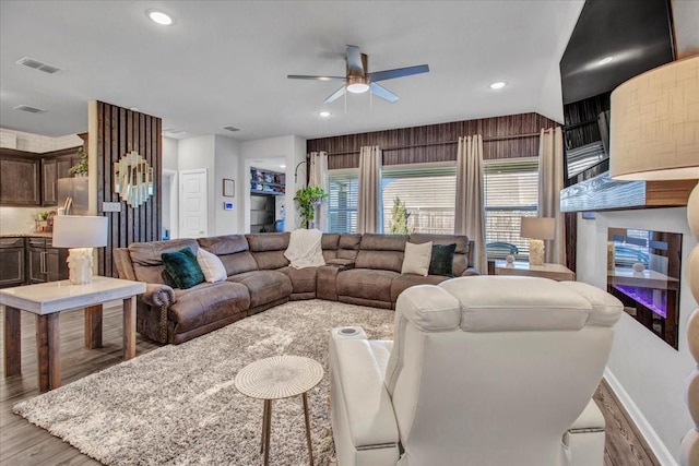 living room with ceiling fan and light hardwood / wood-style floors