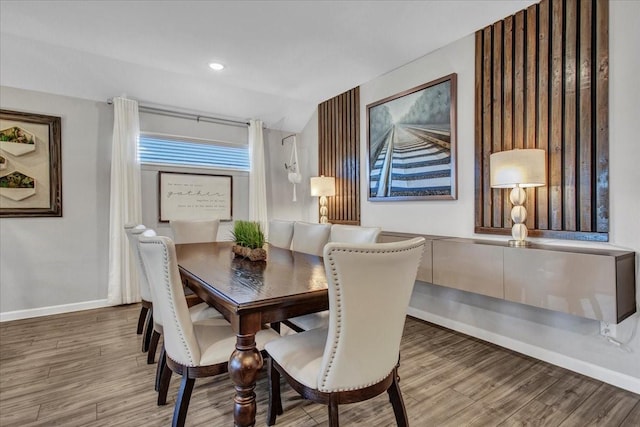 dining space with hardwood / wood-style floors