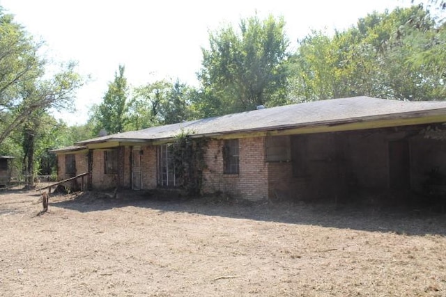 rear view of property featuring a carport