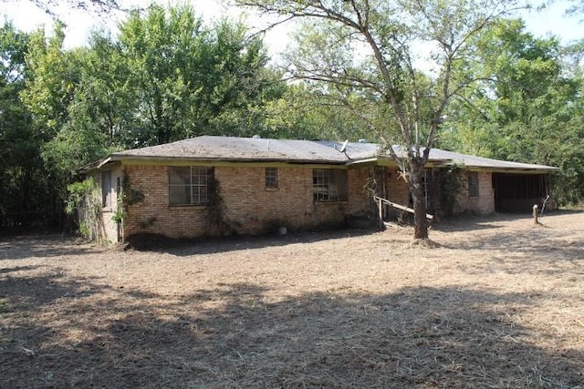 back of property featuring a carport