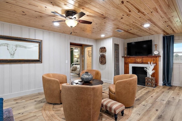 living room featuring light hardwood / wood-style floors and wooden ceiling