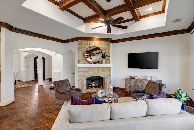 living room featuring dark wood-type flooring, ceiling fan, coffered ceiling, a fireplace, and ornamental molding