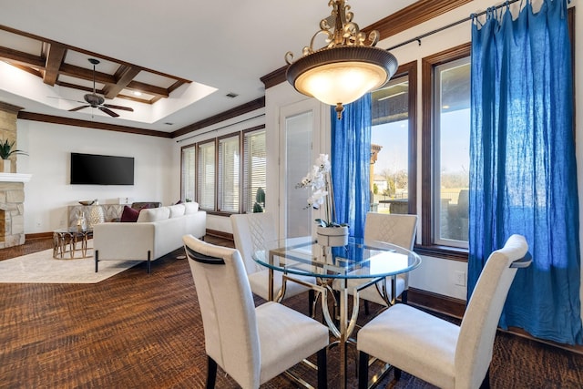 dining area featuring ceiling fan, a healthy amount of sunlight, beamed ceiling, and coffered ceiling