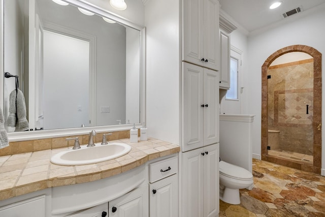 bathroom with toilet, crown molding, an enclosed shower, and vanity