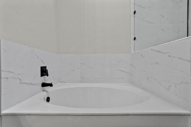 bathroom with a tub to relax in