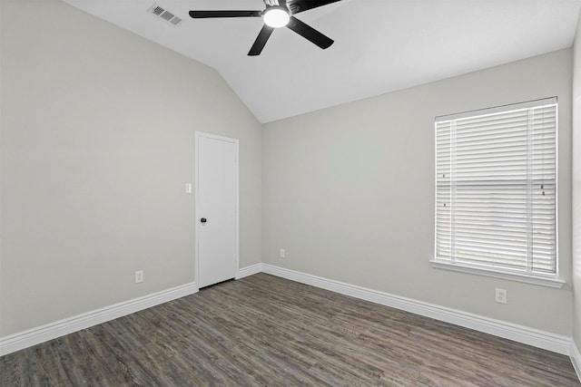 spare room featuring ceiling fan, dark hardwood / wood-style floors, and vaulted ceiling