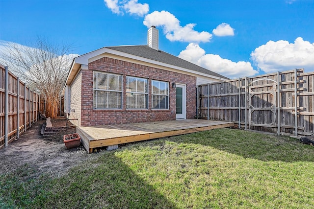 rear view of property with a yard and a deck