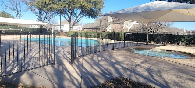 view of swimming pool with a patio area and an in ground hot tub