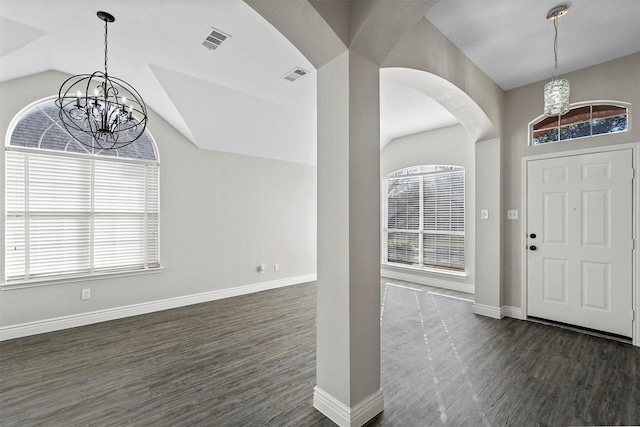 foyer entrance featuring a chandelier, dark hardwood / wood-style flooring, and lofted ceiling