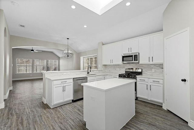 kitchen featuring pendant lighting, a center island, lofted ceiling, and appliances with stainless steel finishes