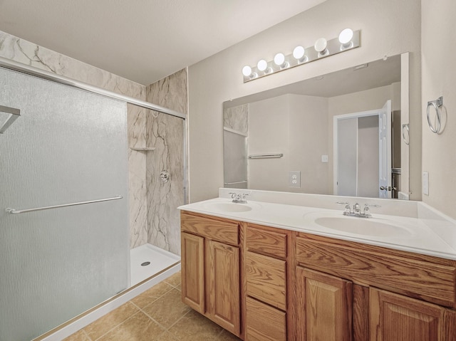 bathroom featuring an enclosed shower, vanity, and tile patterned flooring