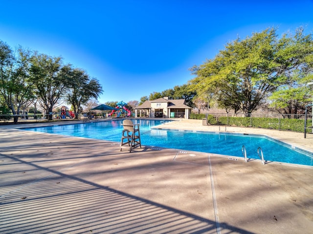 view of pool featuring a playground