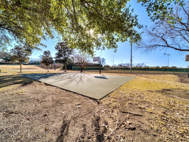 view of home's community featuring basketball court