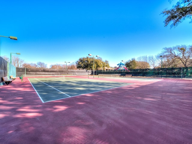 view of sport court with a playground