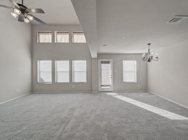 unfurnished living room with light carpet and ceiling fan with notable chandelier