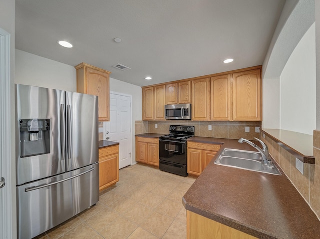 kitchen with stainless steel appliances, tasteful backsplash, sink, kitchen peninsula, and light tile patterned flooring