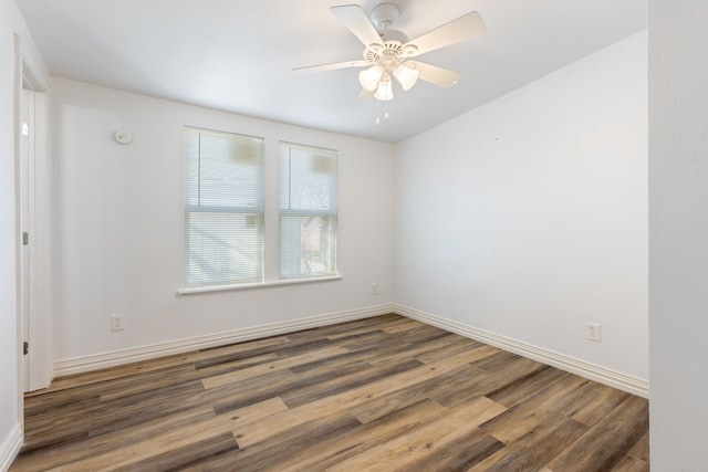 empty room featuring dark wood-type flooring and ceiling fan