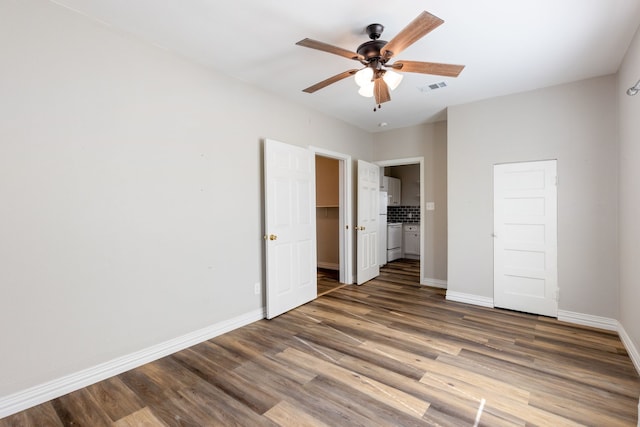 unfurnished bedroom featuring ceiling fan and dark hardwood / wood-style floors