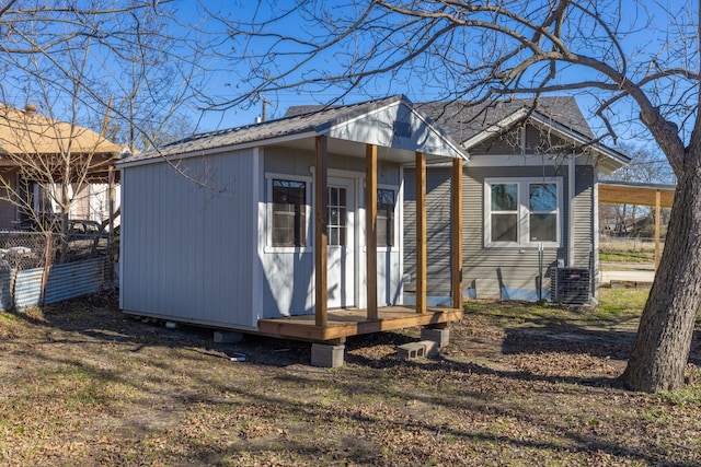 view of front of property with an outdoor structure and central air condition unit