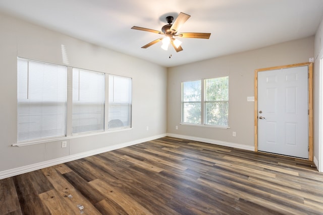 spare room featuring ceiling fan and dark wood-type flooring