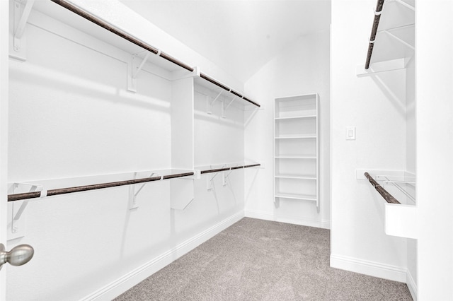 spacious closet with light carpet and lofted ceiling