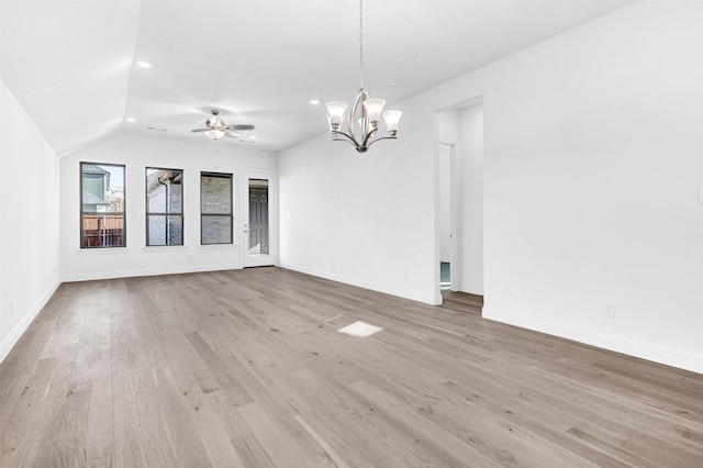 interior space with ceiling fan with notable chandelier and light wood-type flooring