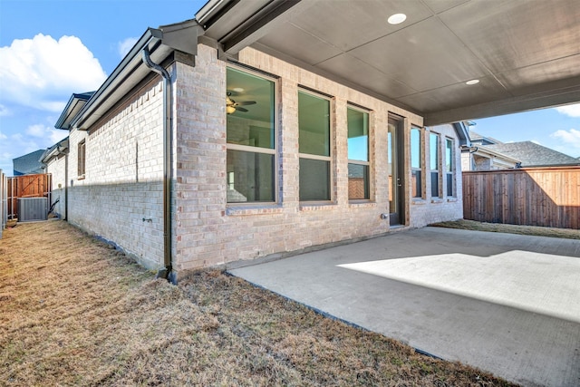 view of side of property featuring central AC unit and a patio