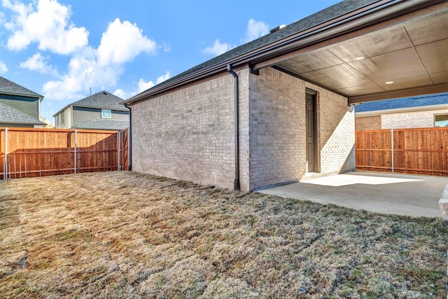 back of house featuring a yard and a patio