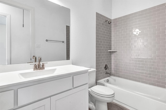 full bathroom with vanity, toilet, and tiled shower / bath