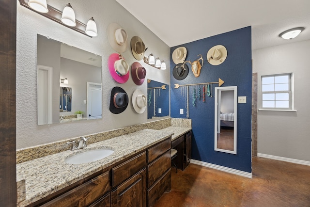 bathroom featuring vanity and concrete floors