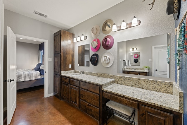 bathroom featuring vanity and concrete flooring