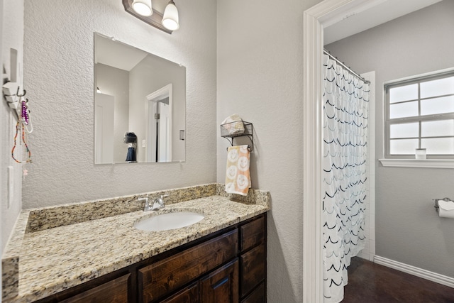 bathroom with a shower with shower curtain and vanity