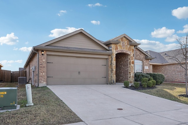 single story home with central AC unit and a garage