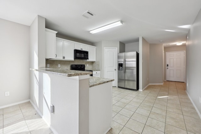 kitchen featuring kitchen peninsula, decorative backsplash, black appliances, light tile patterned floors, and white cabinetry